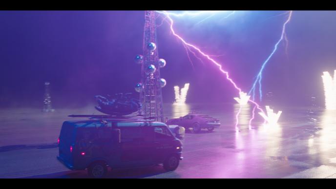 Watkyn's Storm - purple and blue lightning strikes cars in a parking lot