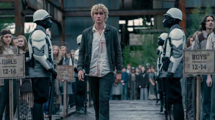 Joseph Zada as Haymitch Abernathy in The Hunger Games: Sunrise on the Reaping. Young Haymitch walks through a crowd at the district 12 reaping