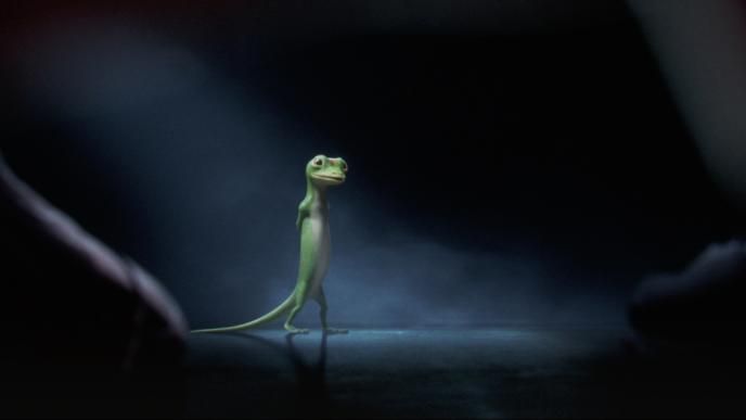 animated geico mascot walking with its hands behind its back