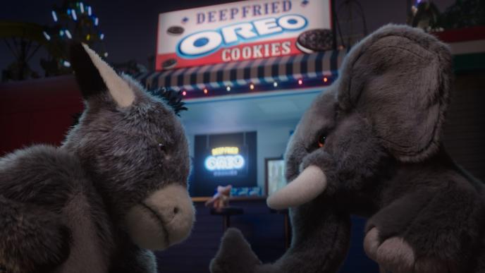 an animated stuffed teddy donkey and elephant standing in front of a deepfried oreo cookie stand. they are looking at each other very frustatingly
