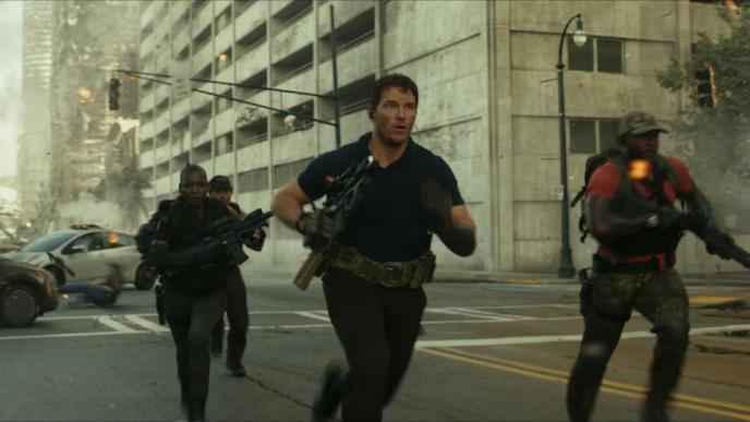 Chris Pratt runs down a smoking city street