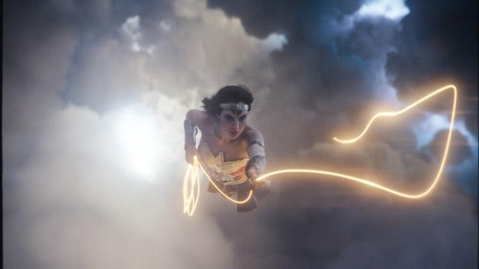 Gal Gadot as Wonder Woman, flying with a golden lasso