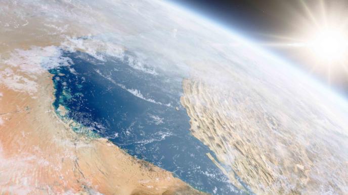 satellite image of earth in space with the sun shining bright in the background