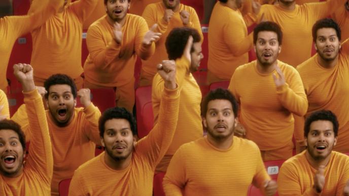 a person in a  yellow long-sleeve duplicated fourteen times, cheering on