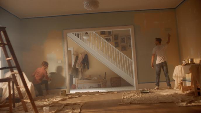 a couple painting the walls of their new home