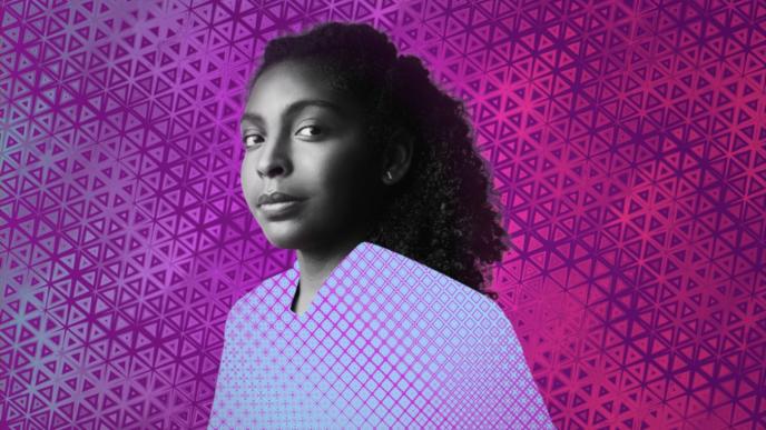 portrait of young person looking into the camera in front of a gradient background
