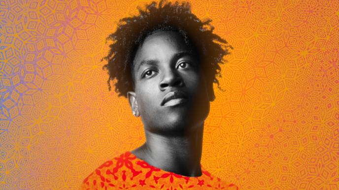 portrait of young person facing forward, looking into the distance in front of an orange background