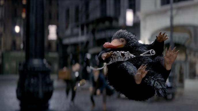 niffler creature from fantastic beasts, mid air, holding a tiara
