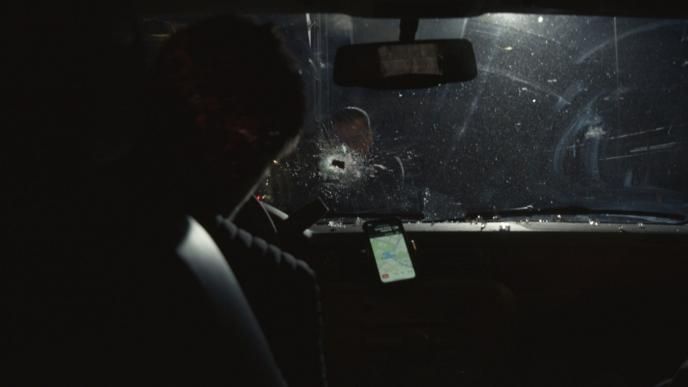 a car windscreen with a bullet hole in it