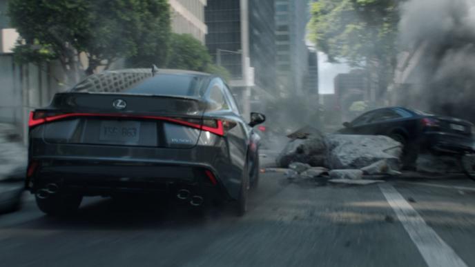 a back shot of a lexus car driving through a destroyed cityscape