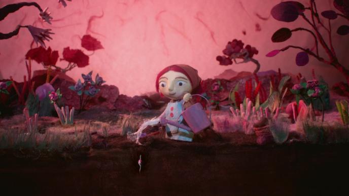 a stop motion character in a garden watering plants