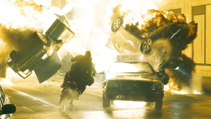 Neo and Trinity weave among exploding cars on a motorbike