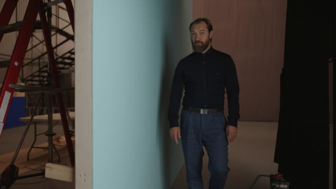 actor jude law standing in front of a film studio
