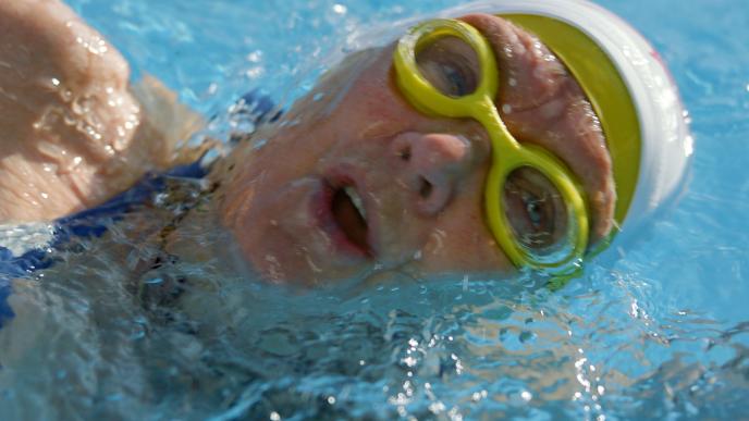 close up of a swimmer during taking a breath while swimming