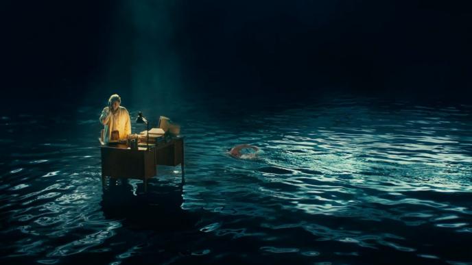 a receptionist holding a phone at a desk floating on dark waters as someone swims by