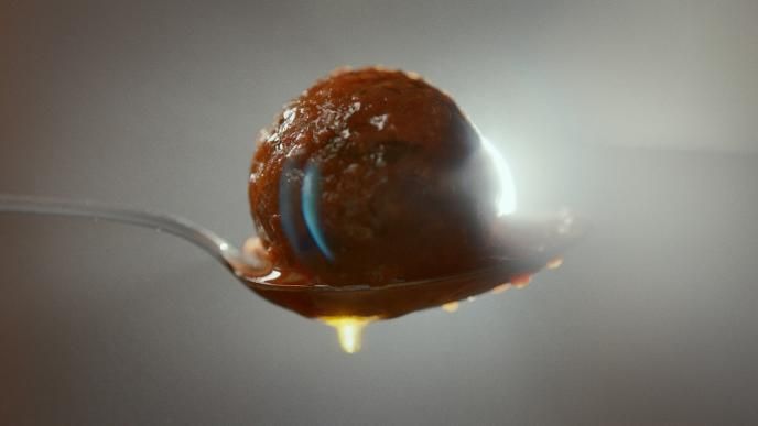 a close up shot of a scoop of ice cream on a spoon