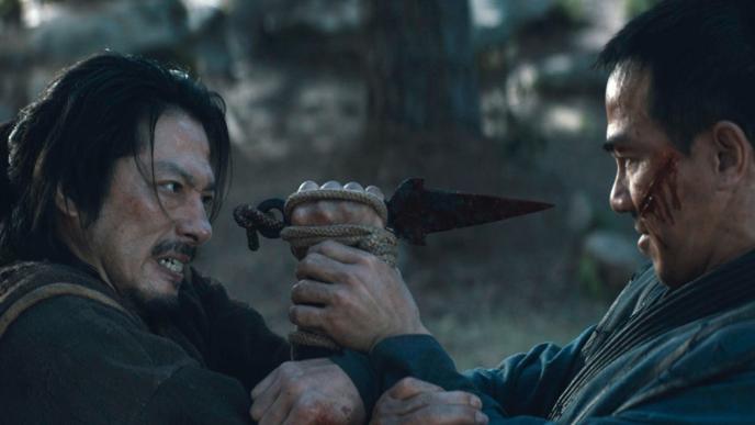 two mortal combat actors mid fight. the actor on the left is holding a dagger towards the other actor