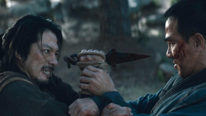 two mortal combat actors mid fight. the actor on the left is holding a dagger towards the other actor