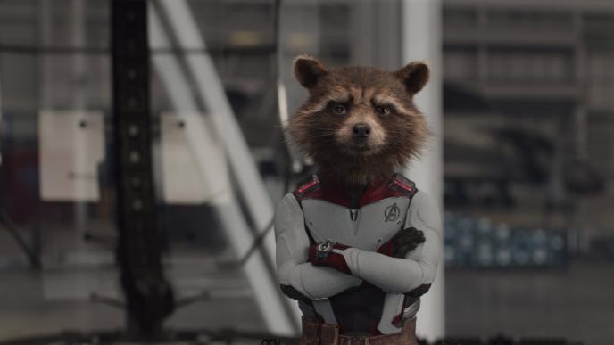 cg animated rocket racoon character wearing an avengers white suit looking up with his arms crossed