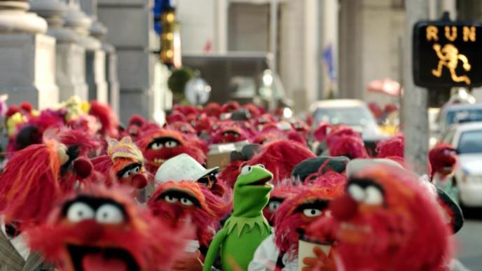 new york city street teeming with red muppet character animal as kermit the frog peaks through the crowd