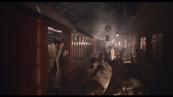 passengers boarding a train at a busy station