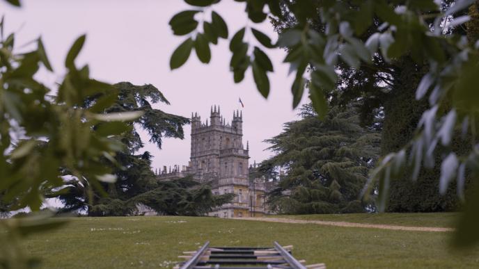 perspective of the royal household building through trees