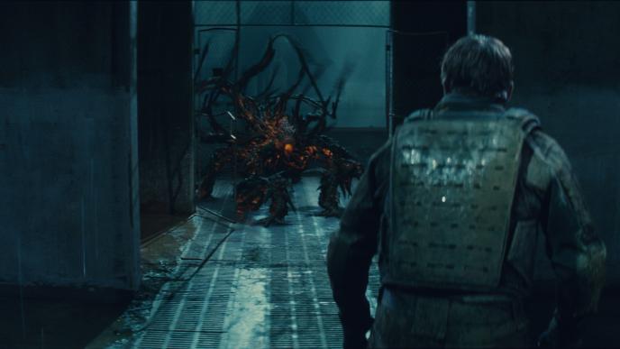 back view of a person in full armour as a monster is in the hallway