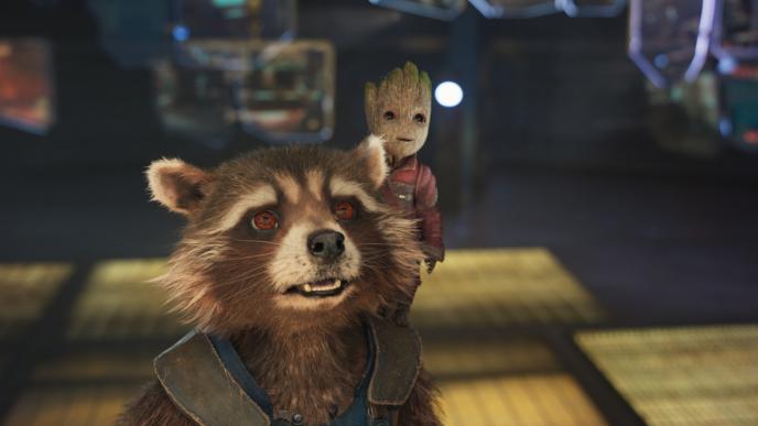 close up of rocket racoon and baby groot. baby groot is standing on rocket's shoulders as they are both looking up