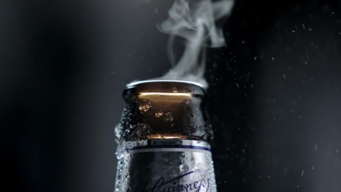 close up of a beer bottle neck with mist coming out of the top