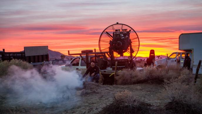 film crew and set up at dusk working on a smoke machine
