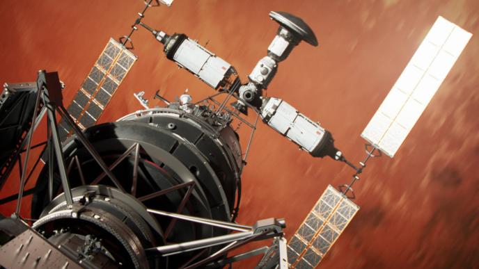a space satellite in front of red planet mars