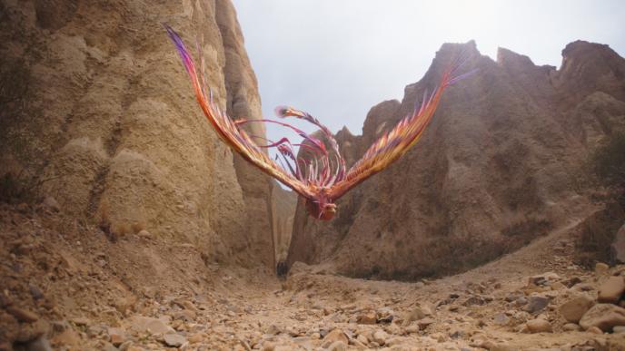 cg animated phoenix from mulan flying through a canyon