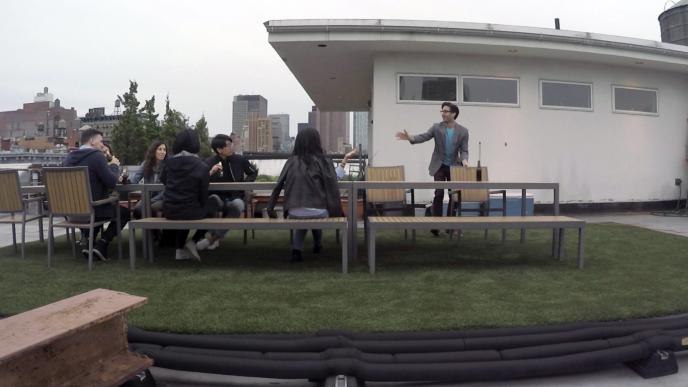 people sitting at a picnic bench on a film set