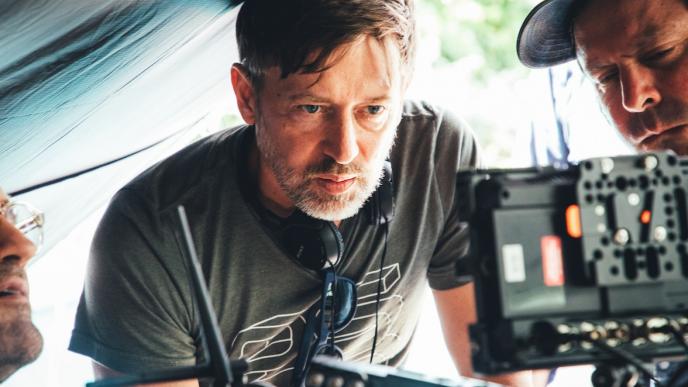 directors looking at a screen behind the scenes