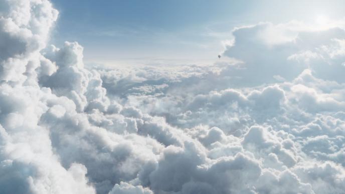 a bright and sunny blanket of clouds in the troposphere as a hot air balloon flies in the distance 