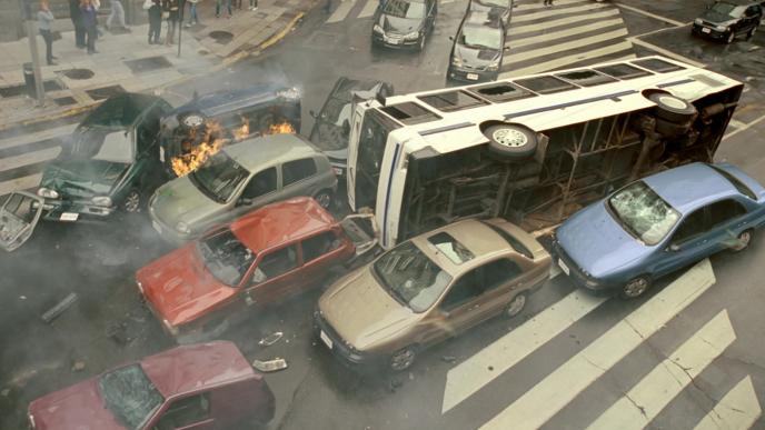 a traffic jam and car crash with a bus on its side
