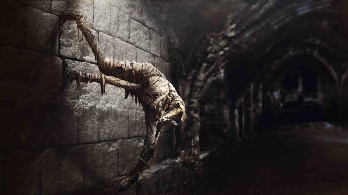 concept art of a cursed mummy hanging from a wall inside of a tomb