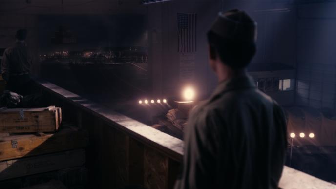 back view of a japanese soldier looking into the distance towards a war zone