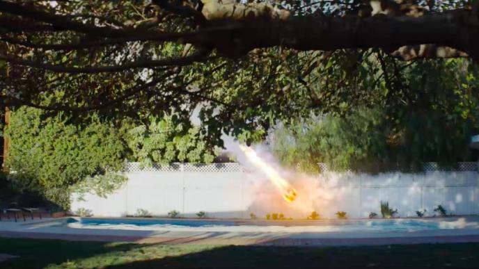 a backyard with a swimming pool. a comet is about to crash into the yard