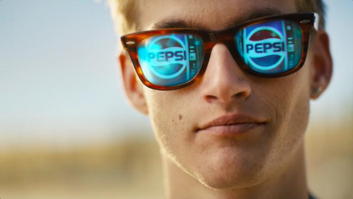 face of a person wearing pepsi branded sunglasses