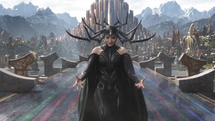 actress cate blanchett as the goddess of death standing between pillars holding out her palms