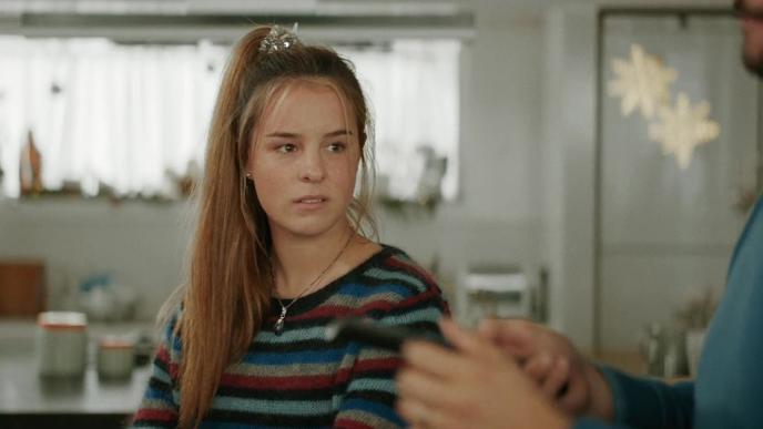 a teenager looking to the right at her father