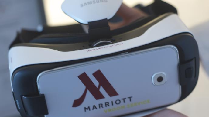 a hand holding a samsung branded marriott vroom service vr headset