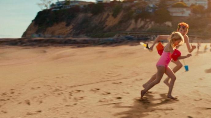 children playing on a sandy beach where there isn't any water