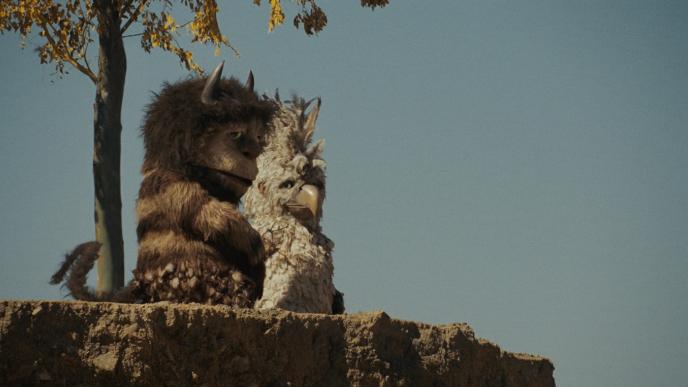 cg animated photorealistic monster characters carol and douglas sitting on top of a cliff