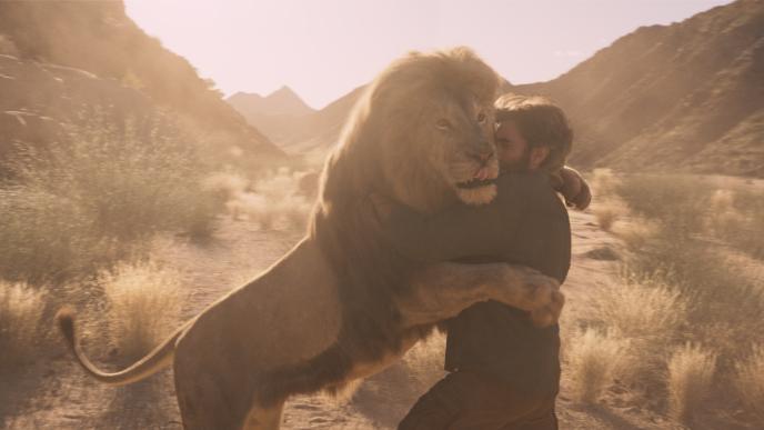 A lion embraces a man