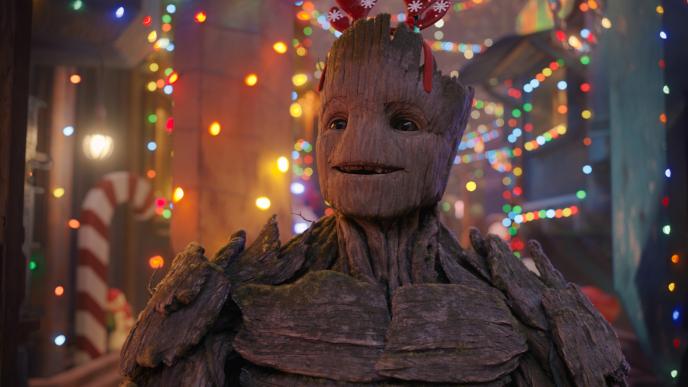 Groot, wearing Christmas antlers and smiling