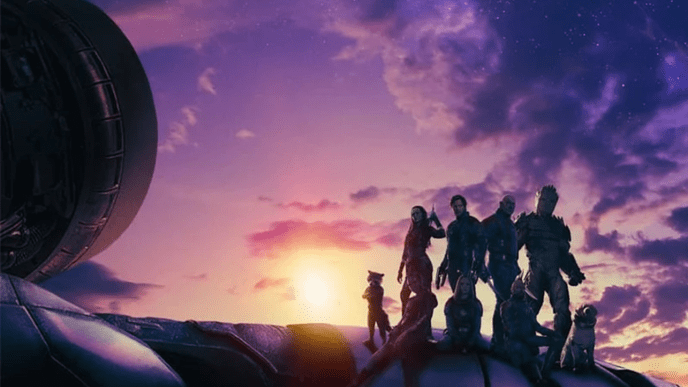 The Guardians of the Galaxy, backlit against a purple swirling galaxy sunset