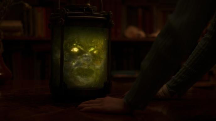 A skull in a jar, it's eye sockets are illuminated and it is surrounded by glowing algae