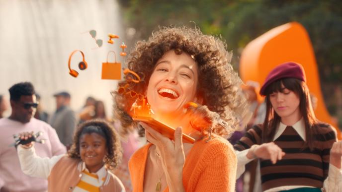 A young woman surrounded by orange glowing sparks
